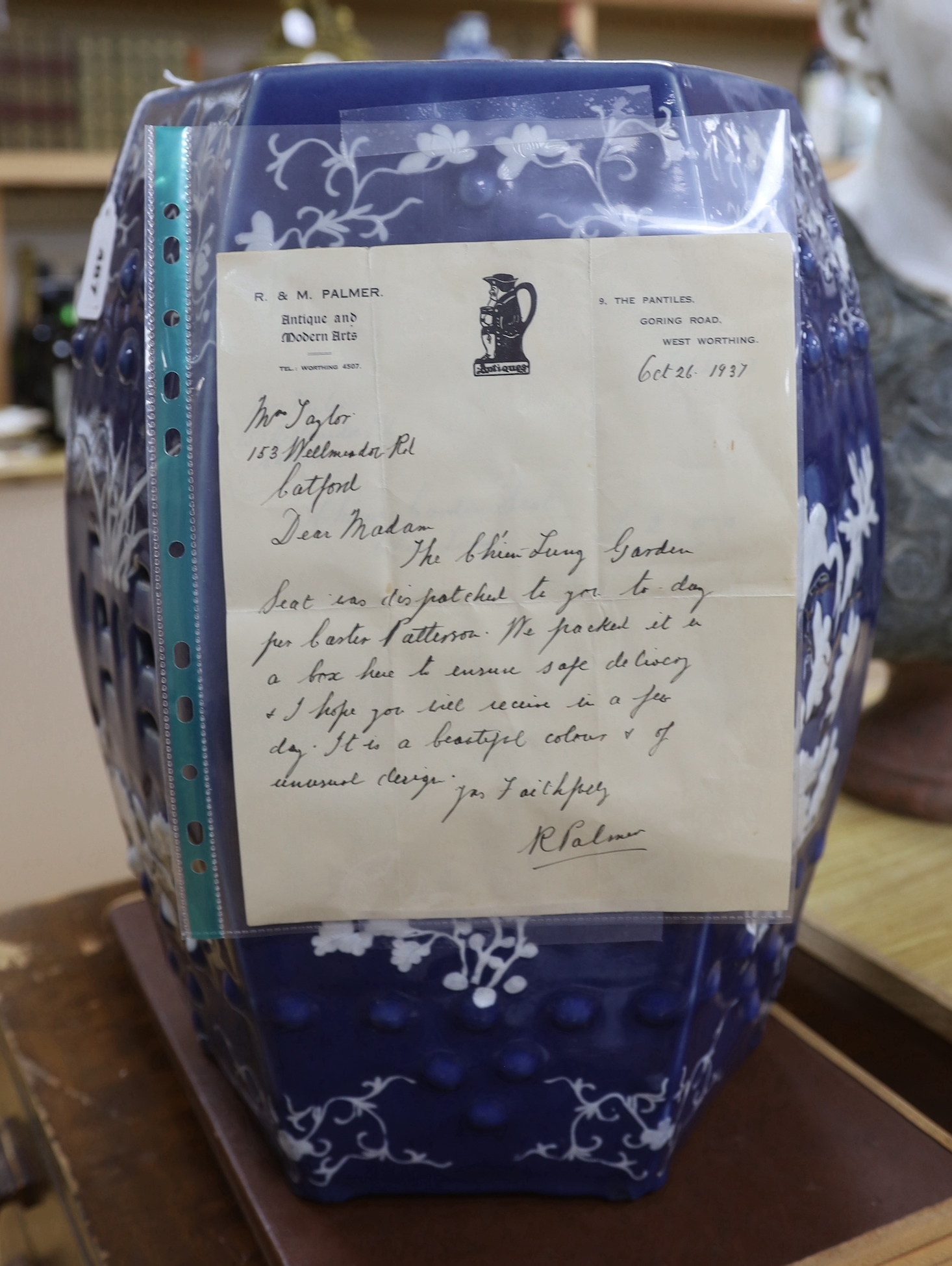 A 19th century Chinese white slip decorated powder blue garden seat, with provenance / paperwork dated to 1937, 48cm high